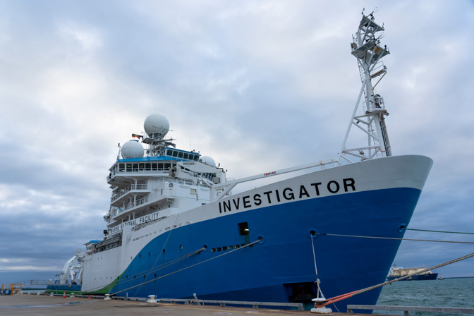Large blue and white ship at the docked