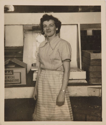 Balck and white photograph of a woman looking directly at the camera