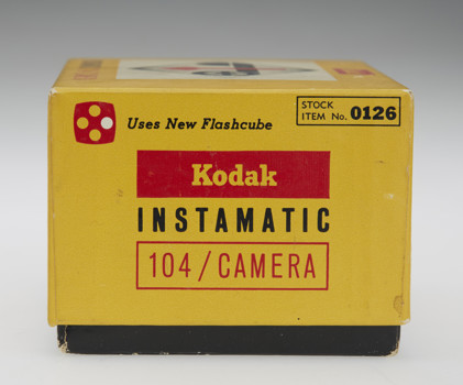 Side view of a yellow camera box. Kodak Instamatic is written on the side in yellow, black and red