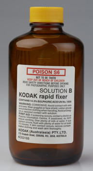 Brown glass bottle with a yellow cap. It has printed white label with a poison warning 