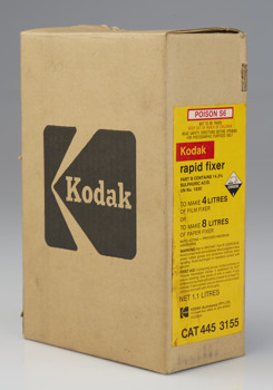 Tall flat box with the kodak logo printed in black on the side. There is yellow label printed in red and black