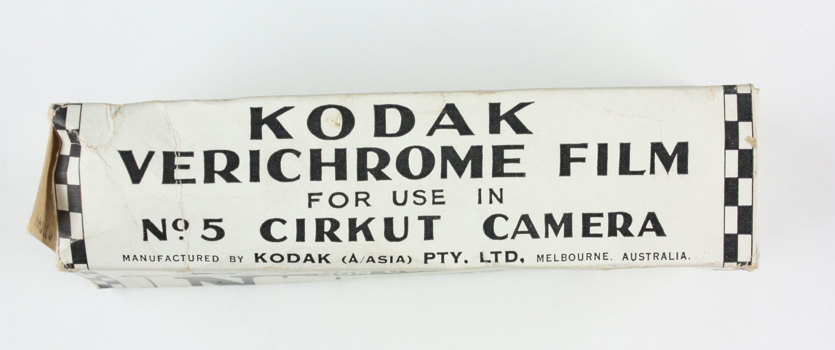 Empty black and white cardboard box; opened; black and white sticker adhered to one side.