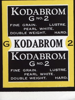 Small colour printed label. Yellow, black and white background with black and white text.