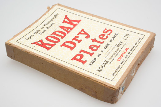 Brown cardboard box with a paper label with red and black text