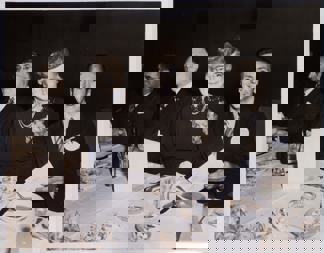 Man and a woman seated at a table set for a dinner function