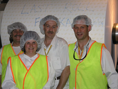 Four people infront of large paper roll