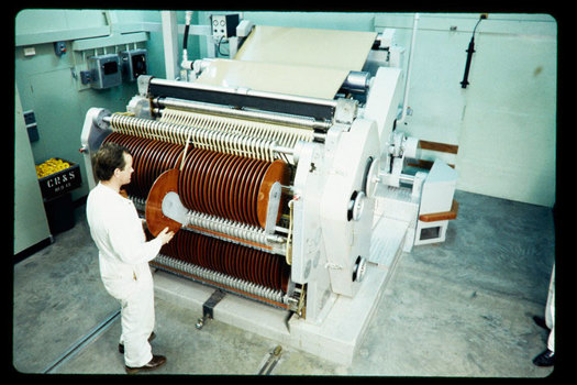 Man operating a larger machine with rollers