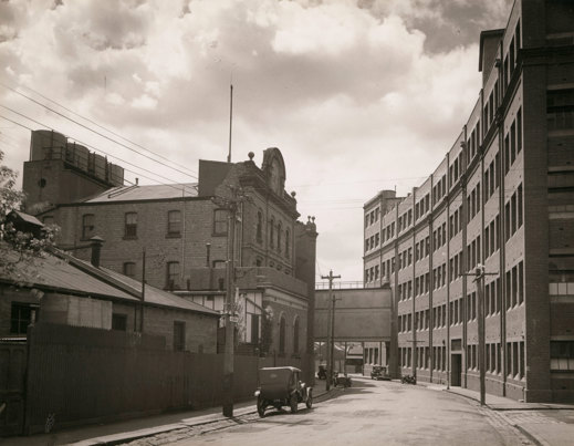Curved street lined with multi-story brick buildings