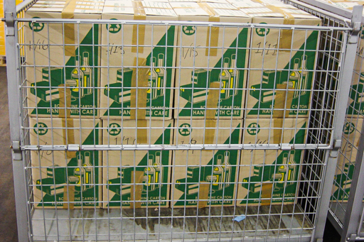 Two rows of packing boxes stacked up in a metal cage