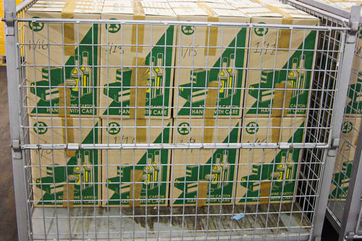 Two rows of packing boxes stacked up in a metal cage