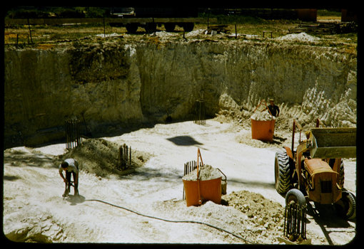 Excavation site with a tractor and a workman