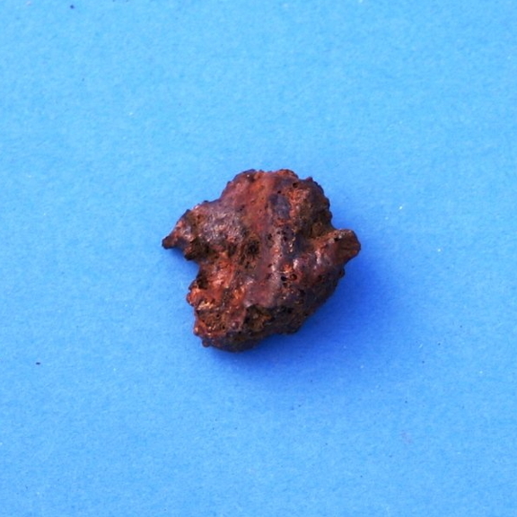 Samll red rock on a blue background