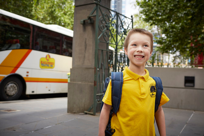 Boy in school uniform visiting Immigration Museum.