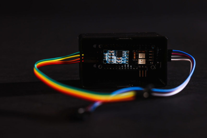 A circuit board with computer components. Various coloured wires connect to the board.