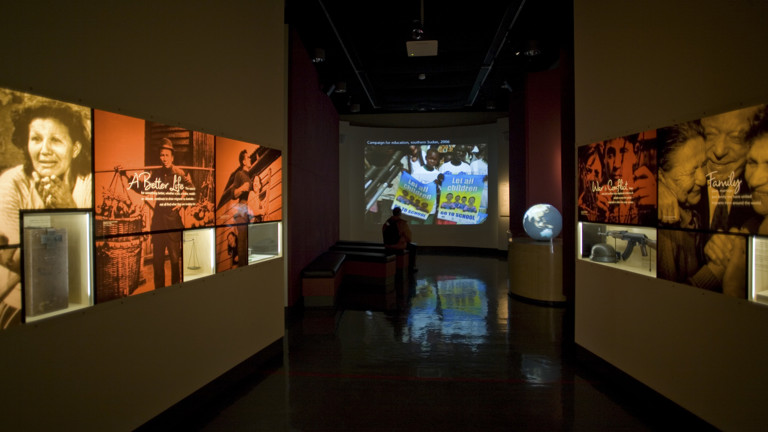A film theatre with museum exhibits in the left and right hand side of the screen.