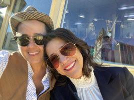 People smiling and leaning against each other