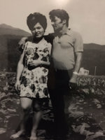 Man and woman standing in field.