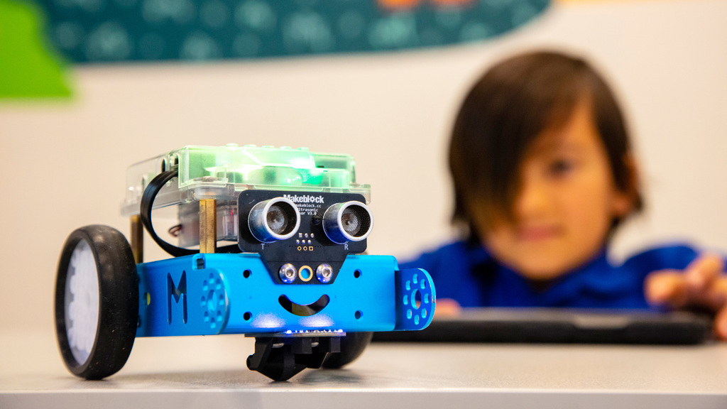 Primary School student using an iPad to program a robotic vehicle, in the STEM Learning LAB at Scienceworks