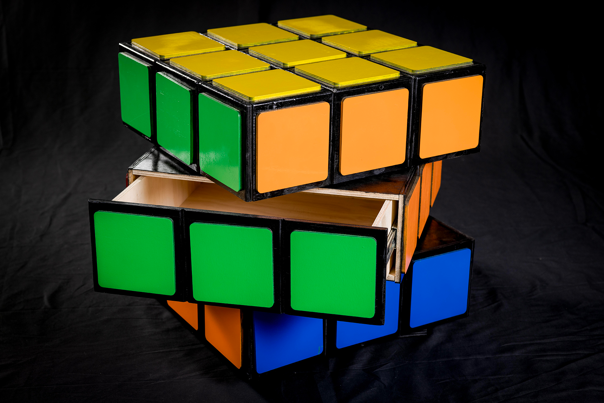 A set of wooden drawers that resemble a Rubic’s Cube, stacked on diagonal angles.