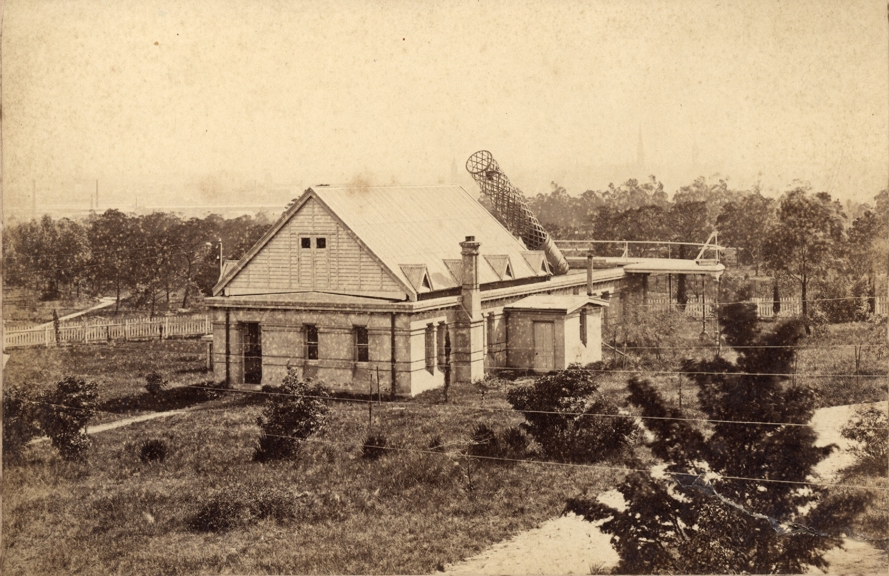 Albumen photograph of the Great Melbourne Telescope House at Melbourne Observatory and surrounding gardens. Three spires are dimly visible in the background.