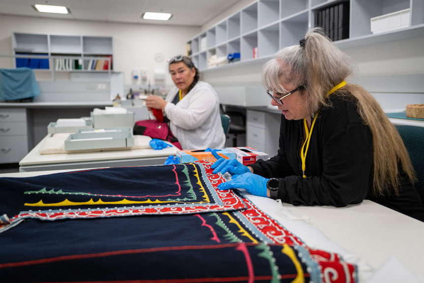 Two women looking over colourful garments