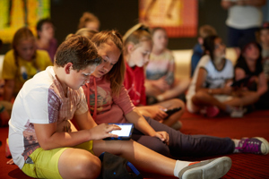 Primary school students sitting down with IPAD for the 'Our Shared History' program.