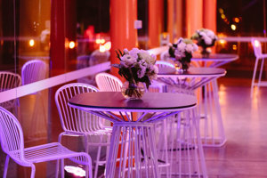 High white round tables with a vases of white flowers
