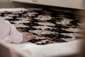 A young girl connecting with a kahuhuruhuru.