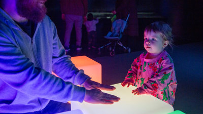  Family in the Book Nook area of the Beyond Perception exhibition during Little Kids Day In program at Scienceworks.