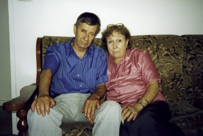 A woman and man sitting on a couch