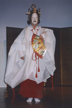 A woman on stage in traditional Japanese costume
