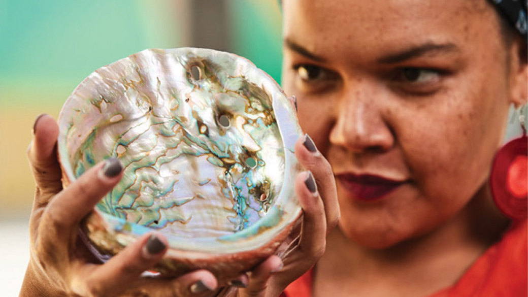 A museum worker inspects a specimen.