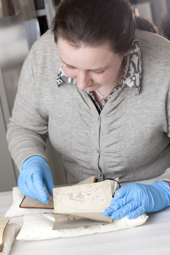 Museum Victoria Volunteer with World War 1 diaries.