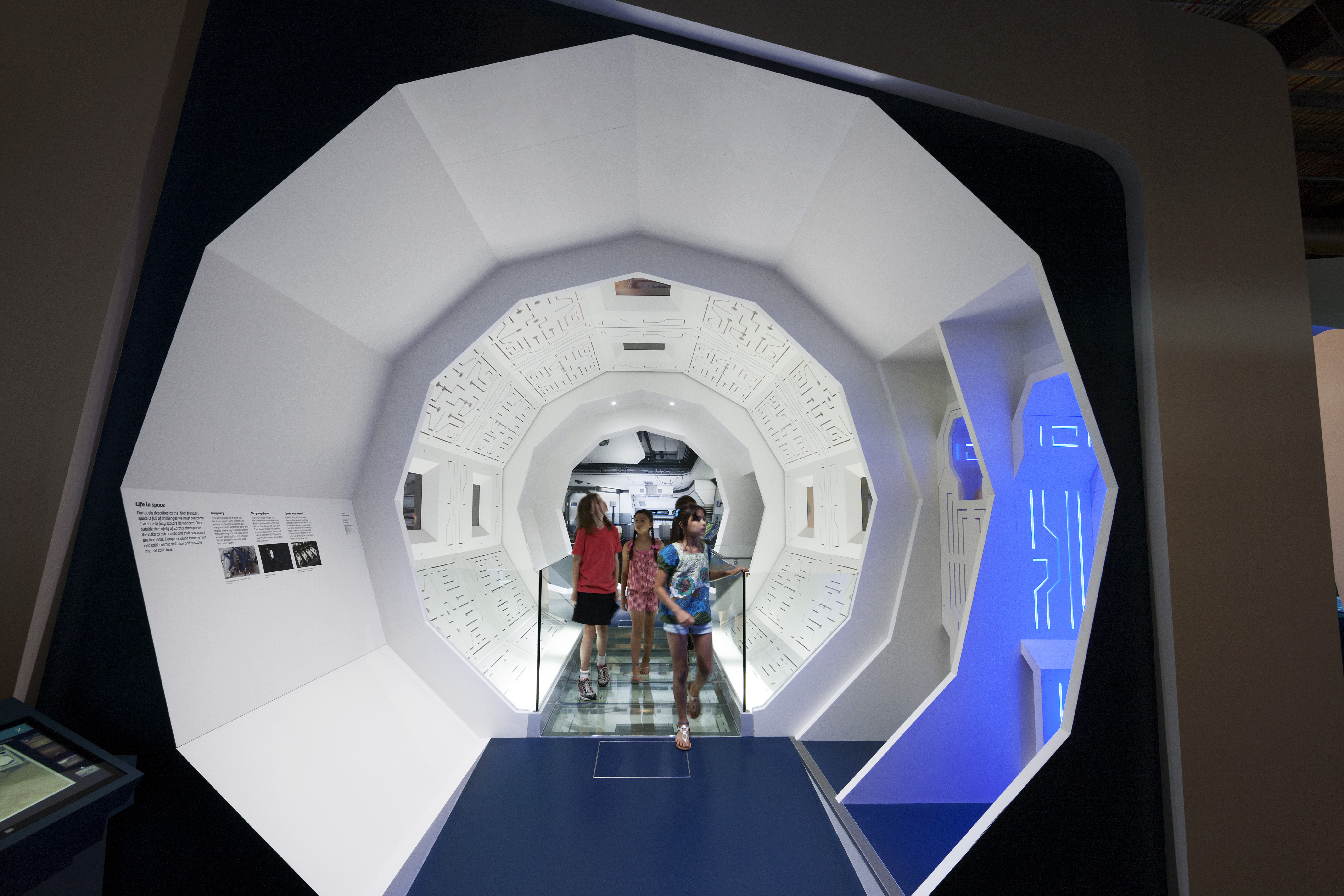Children walking through a futuristic hallway at the Scienceworks Museum