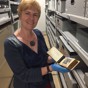 Woman in museum collection store showing and object