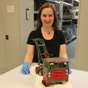 Woman in museum collection store with a toy truck