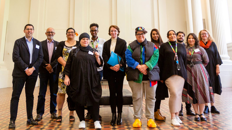  Group photo of the Inclusion Working Group in the Long Room of the Immigration Museum.
