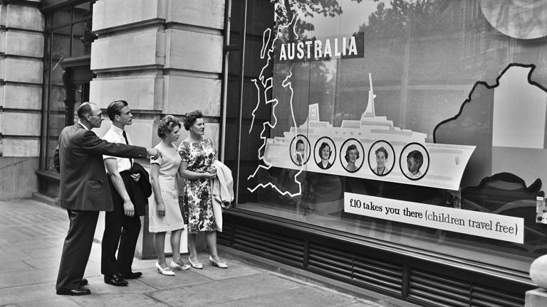 Two men and two women looking in a shop window