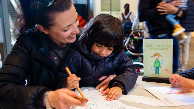 Family making their own Bunjil Feather Bookmark at Melbourne Museum. 