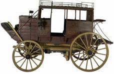 A horse-drawn passenger stage coach