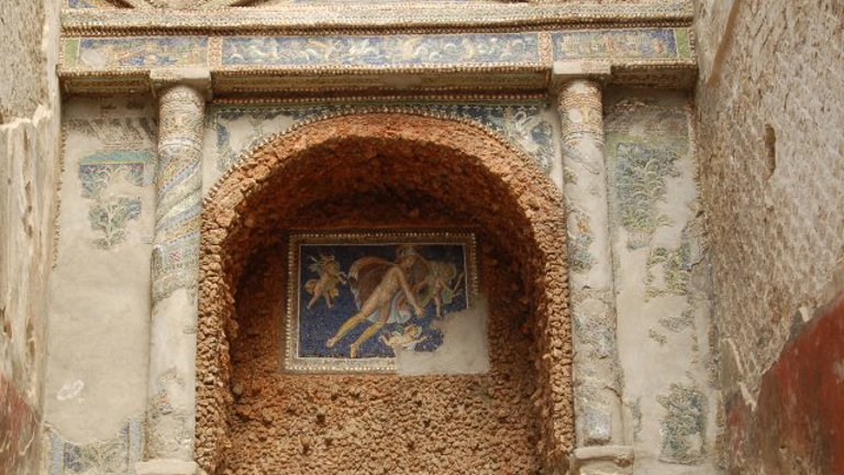 Mosaic depicting a godlike figure surrounded by three children