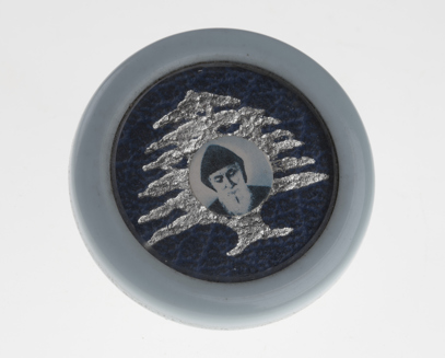 Blue plastic icon with image of St Charbel in centre.