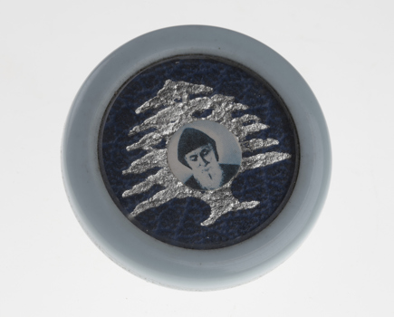 Blue plastic icon with image of St Charbel in centre.