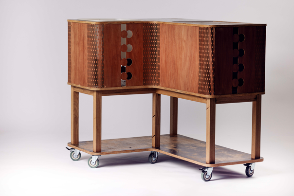 Wooden recycling station on wheels with perforated panels and circular cutouts.