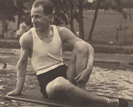 Karl Muffler posing in bathing costume on diving board. 