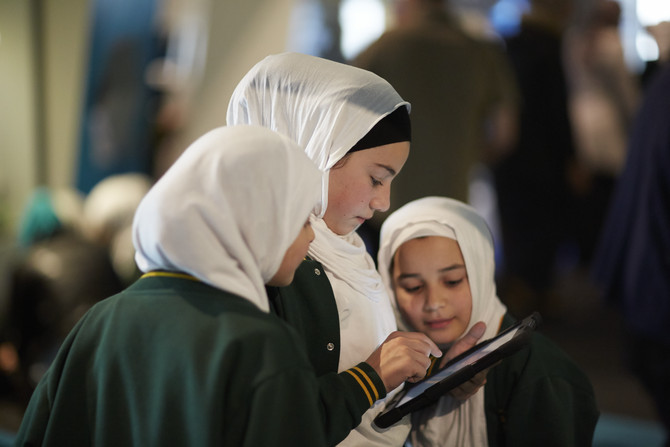 Three students using iPad