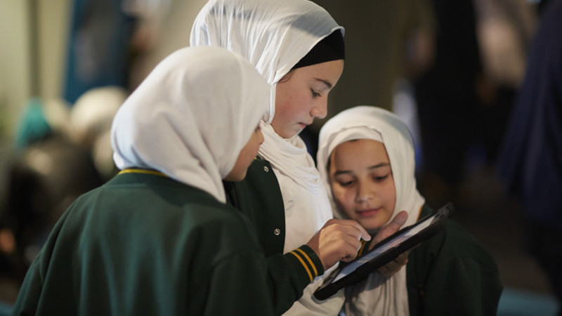 Three students using iPad