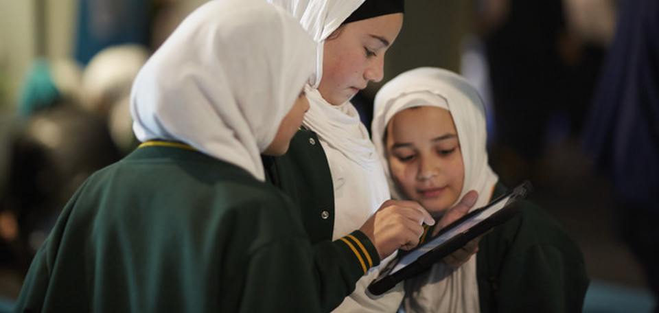 Three students using iPad