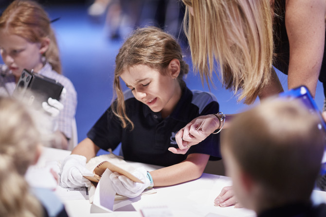 Teacher instructing student on how to handle objects