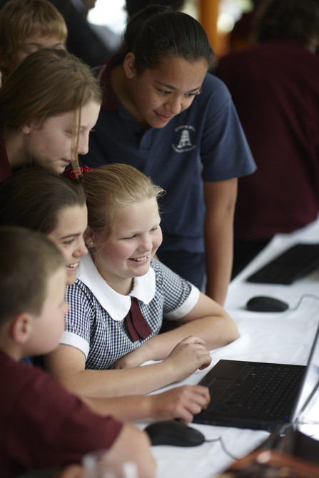Students gathered around a computer